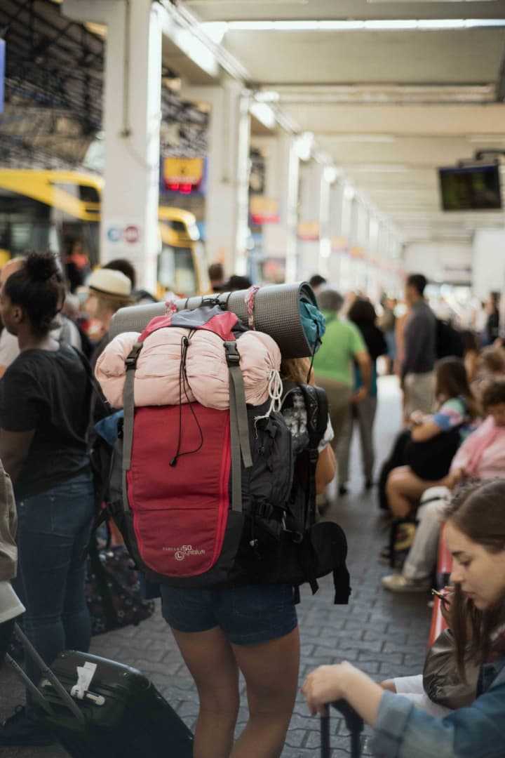 A backpacker in a bus station